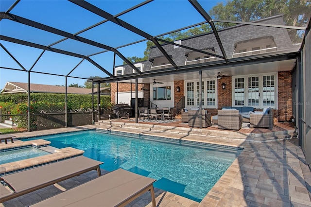 view of pool with french doors, an outdoor living space, ceiling fan, glass enclosure, and a patio area