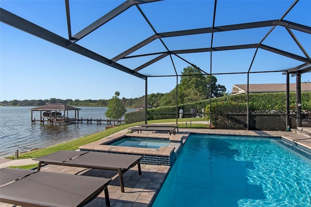 view of swimming pool with an in ground hot tub, a boat dock, a water view, glass enclosure, and a patio area