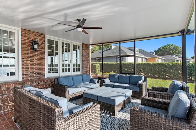 sunroom / solarium featuring ceiling fan