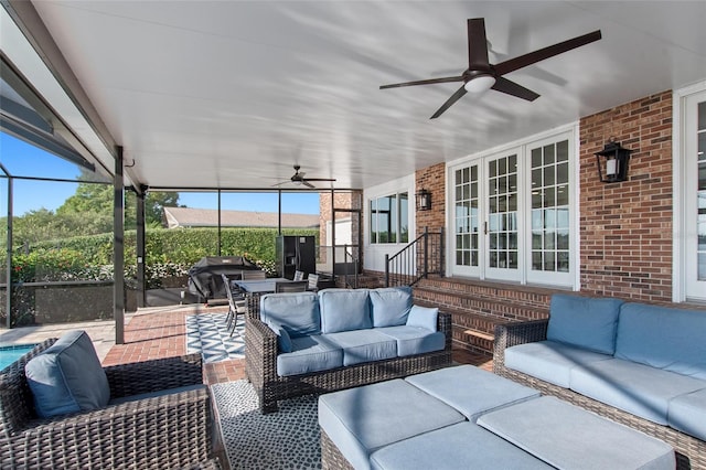 sunroom / solarium featuring ceiling fan