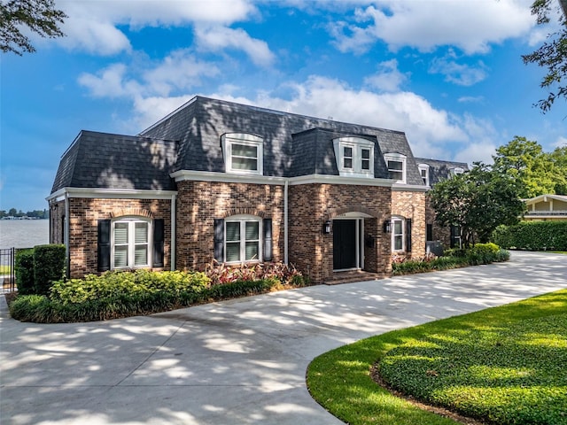 french country inspired facade featuring a front lawn