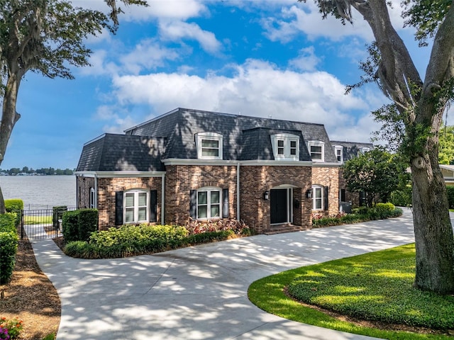 french country inspired facade featuring a water view