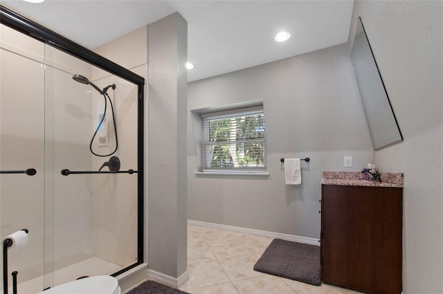 bathroom with tile patterned flooring, vanity, toilet, and a shower with shower door