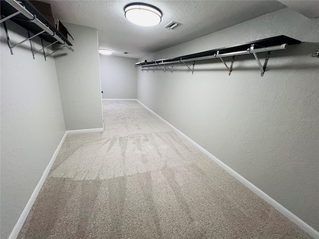 walk in closet with carpet floors