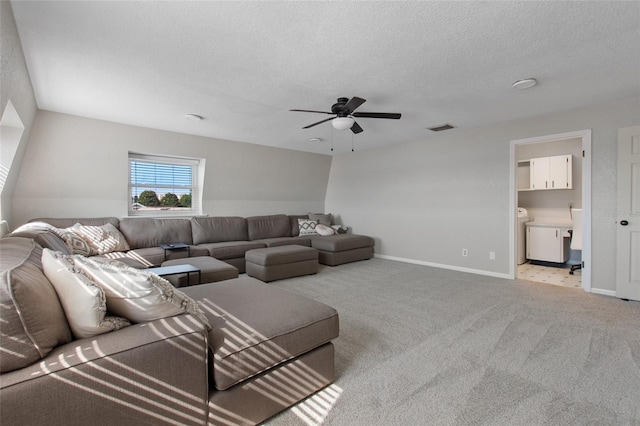 carpeted living room with a textured ceiling and ceiling fan