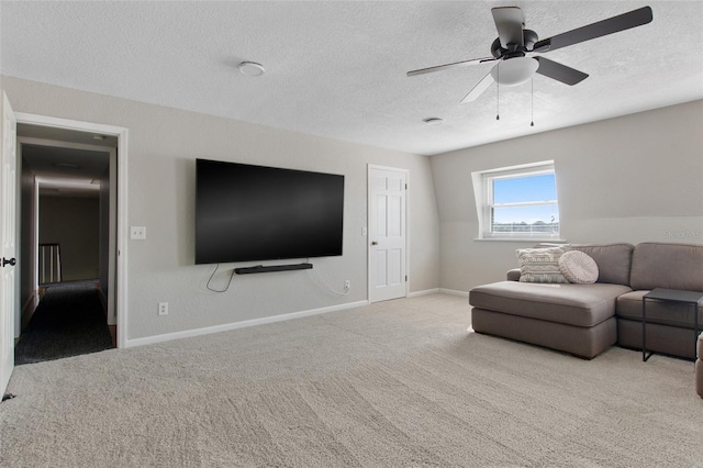 carpeted living room with ceiling fan and a textured ceiling