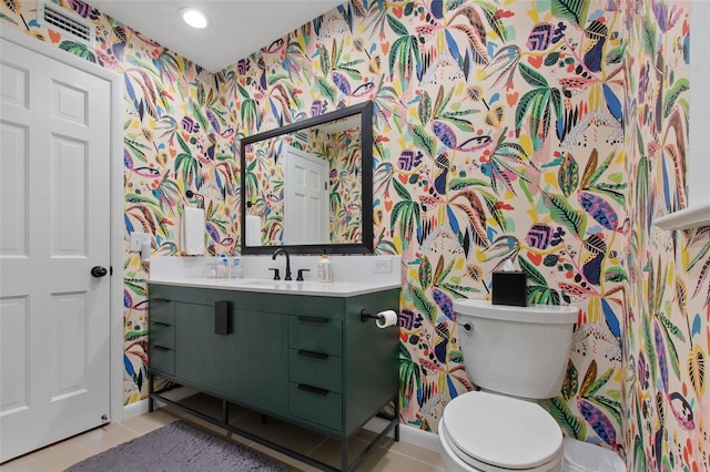 bathroom featuring toilet, vanity, and tile patterned floors