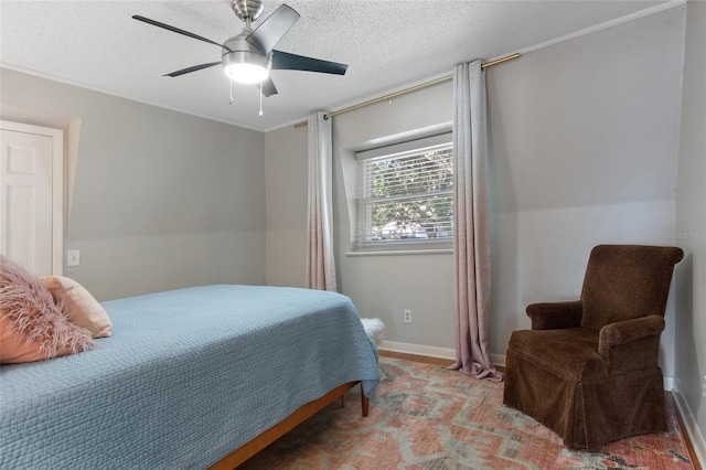 bedroom with ceiling fan and a textured ceiling