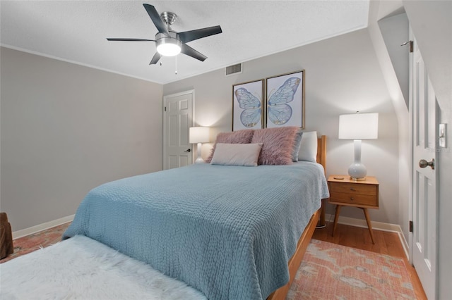 bedroom featuring hardwood / wood-style flooring and ceiling fan