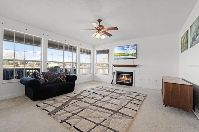 living room featuring light carpet and ceiling fan