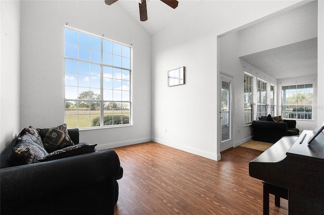 living room with hardwood / wood-style flooring, a wealth of natural light, high vaulted ceiling, and ceiling fan