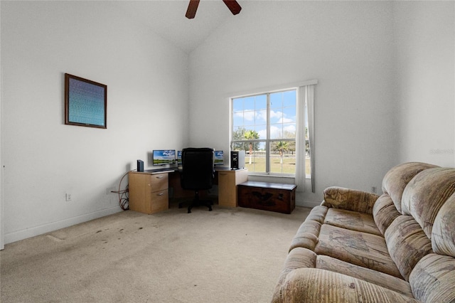 carpeted office space featuring ceiling fan and high vaulted ceiling