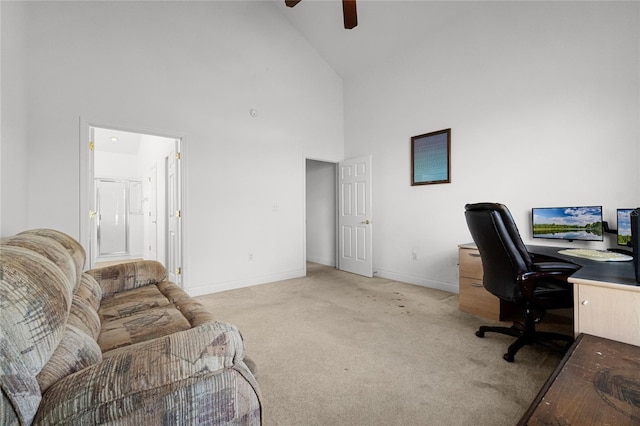 carpeted home office with high vaulted ceiling