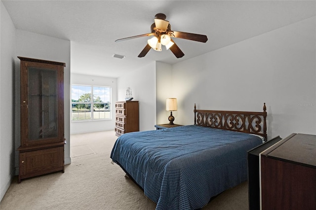 bedroom with ceiling fan and light colored carpet