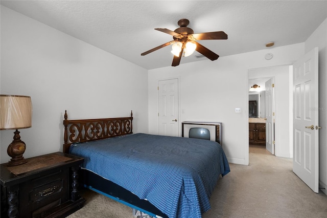 bedroom with light carpet, ceiling fan, and a textured ceiling