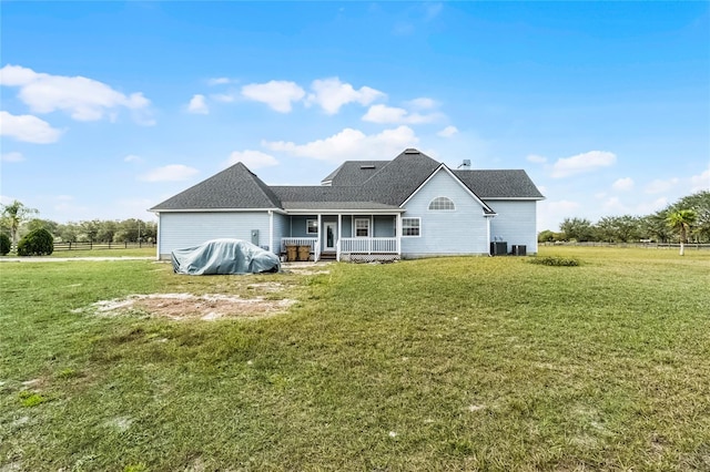 rear view of property with a porch and a lawn