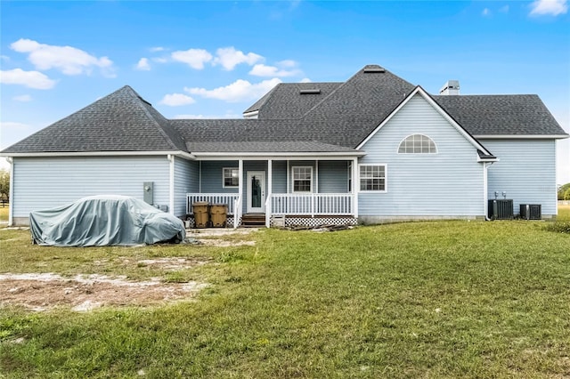 back of house with a porch, a yard, and central air condition unit