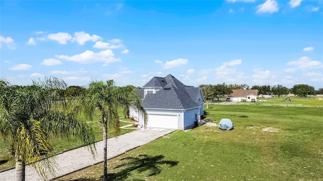 view of side of property with a garage and a lawn