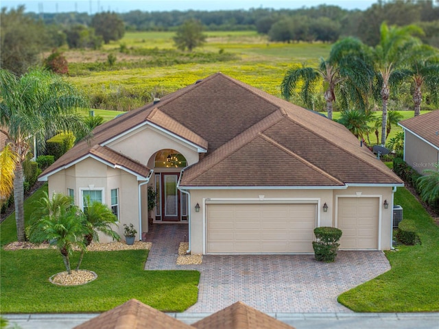 view of front of home featuring a garage and a front yard