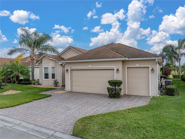 ranch-style house with a front lawn, decorative driveway, an attached garage, and stucco siding