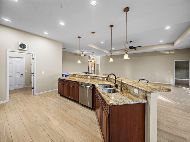 kitchen featuring pendant lighting, a large island, stainless steel dishwasher, open floor plan, and a sink