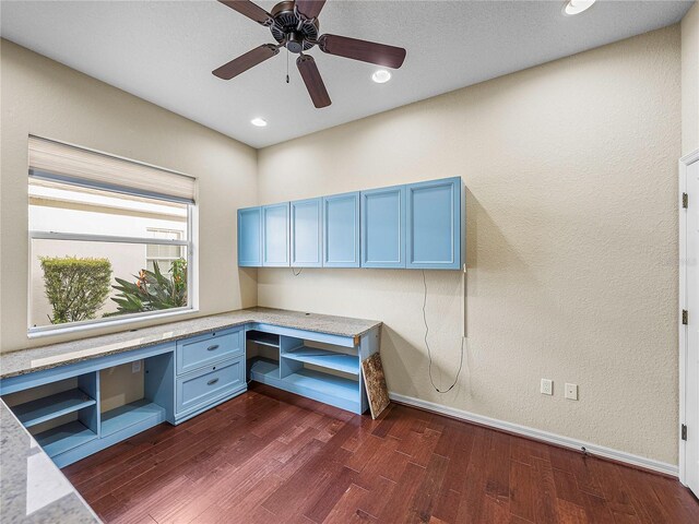 unfurnished office featuring baseboards, built in study area, ceiling fan, dark wood-style flooring, and recessed lighting