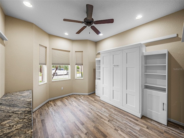 unfurnished bedroom with recessed lighting, a closet, a ceiling fan, light wood-type flooring, and baseboards