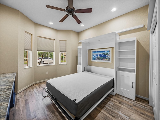 bedroom featuring dark wood-style floors, baseboards, a ceiling fan, and recessed lighting