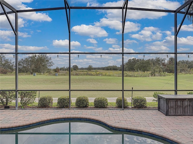 view of swimming pool with a lanai, a patio area, and a yard