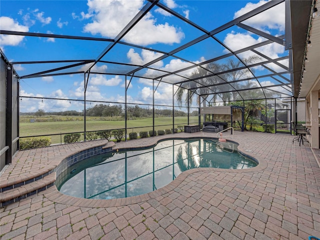 outdoor pool with a lanai, a hot tub, and a patio