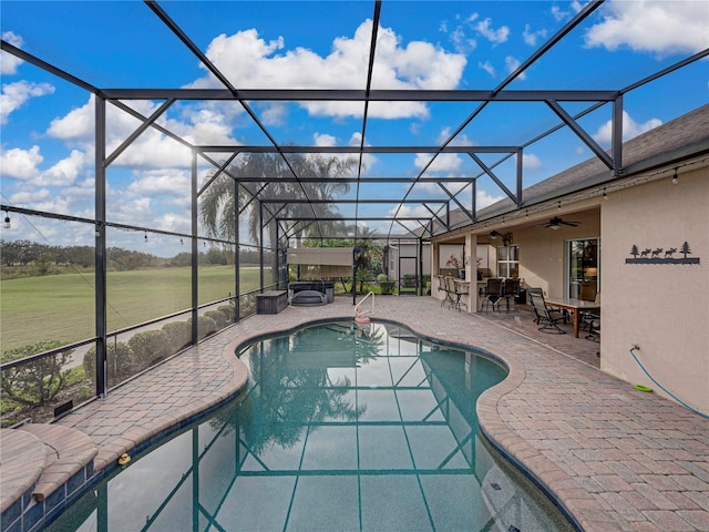 outdoor pool with a patio, glass enclosure, a jacuzzi, exterior bar, and a ceiling fan