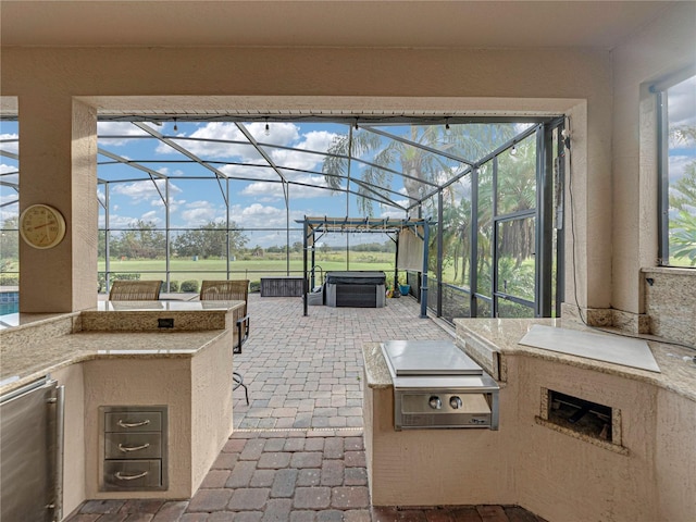 view of patio featuring a bar, a hot tub, and area for grilling