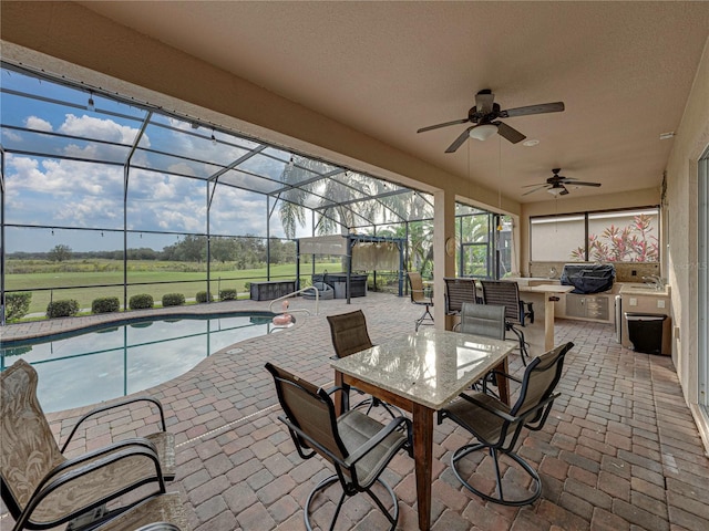 view of patio / terrace with an outdoor pool, a ceiling fan, area for grilling, glass enclosure, and outdoor dining area