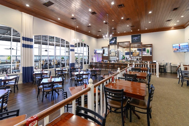 dining space with wooden ceiling, visible vents, ornamental molding, and a wealth of natural light