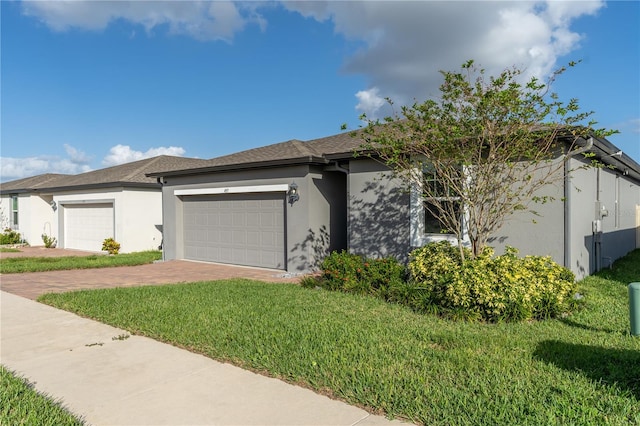 view of front of house featuring a front yard and a garage