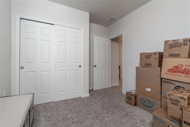 interior space featuring a textured ceiling and a closet