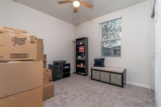 office featuring a textured ceiling, light colored carpet, and ceiling fan