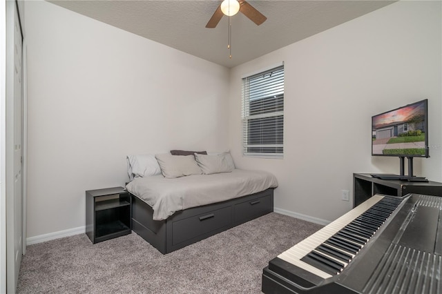 bedroom featuring carpet, a textured ceiling, and ceiling fan