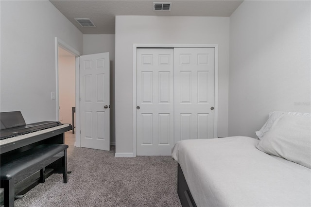 bedroom with light colored carpet and a closet