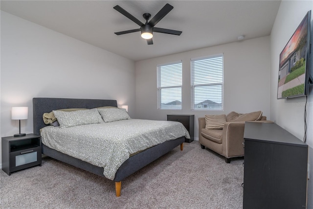 bedroom featuring light colored carpet and ceiling fan