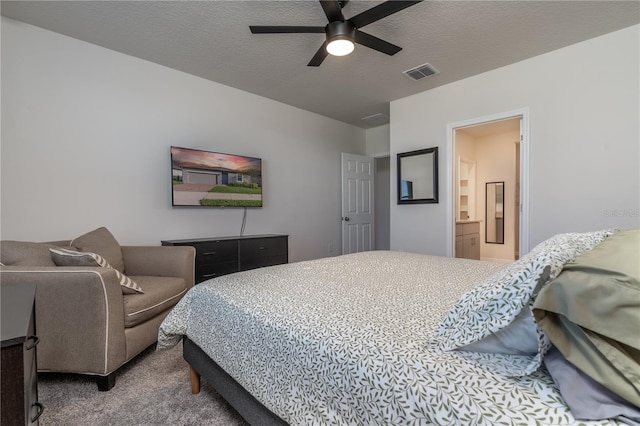 bedroom featuring a textured ceiling, ceiling fan, carpet flooring, and ensuite bathroom