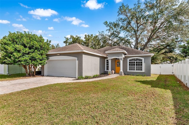 view of front of home featuring a front yard and a garage