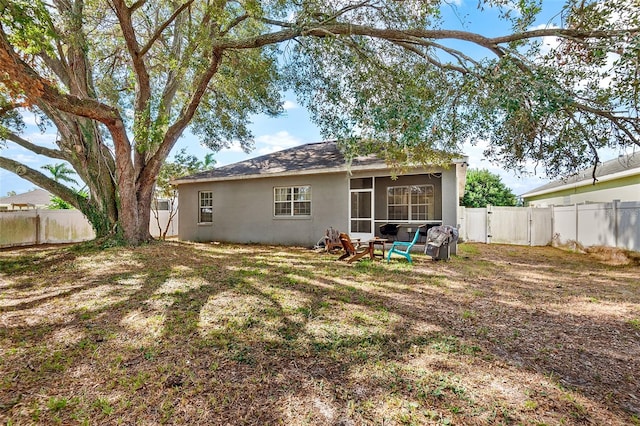 rear view of house featuring a sunroom