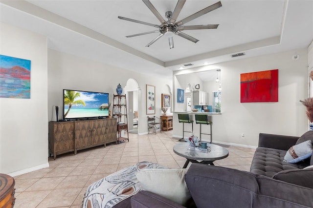 living room with ceiling fan and light tile patterned floors