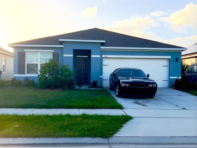 535 Noble Ave, Davenport, FL 33837 - ranch-style house with concrete driveway, an attached garage, stucco siding, roof with shingles, and a front lawn