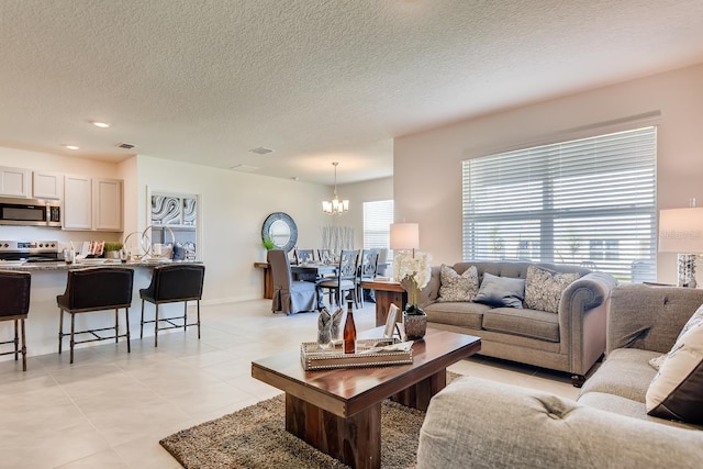 535 Noble Ave, Davenport, FL 33837 - living area featuring a chandelier, a textured ceiling, light tile patterned floors, and recessed lighting
