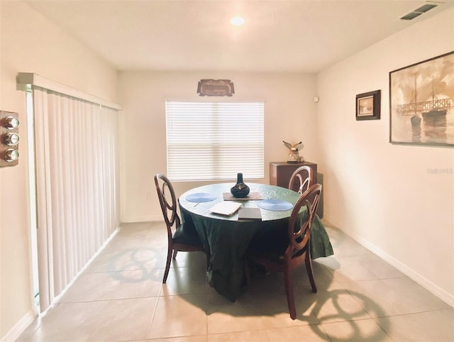 dining area with light tile patterned floors