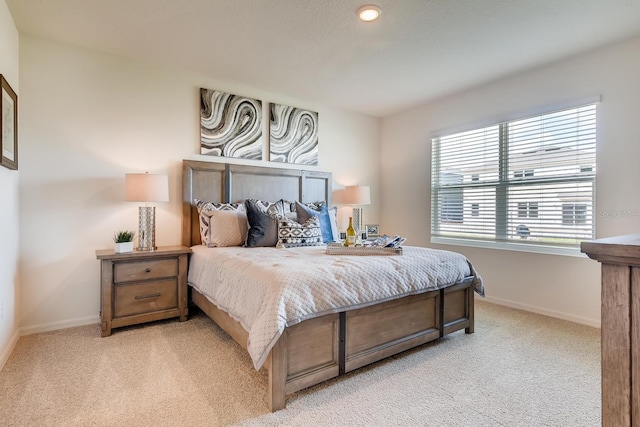 carpeted bedroom with multiple windows