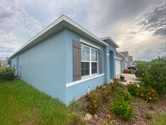 view of side of home featuring a garage