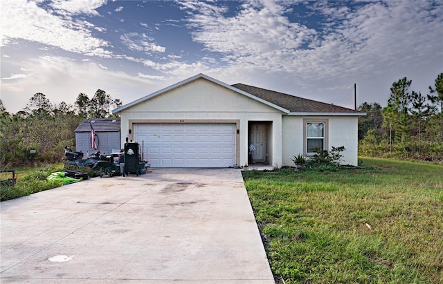 single story home with a front yard and a garage